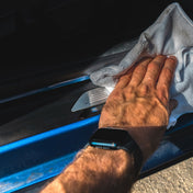 microfibre cloth wiping away dirt from car door sill