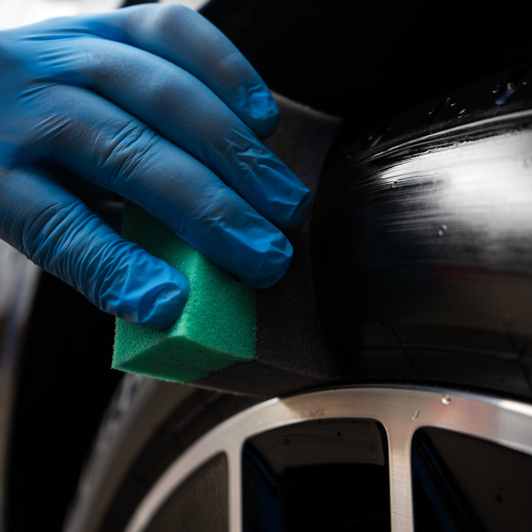 tyre dressing being applied to tyre using applicator puck
