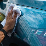 quick detailer being wiped away with white microfibre cloth