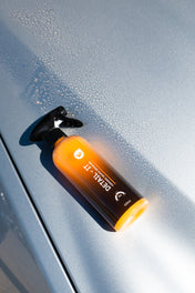 quick detailer laid on hood of silver car