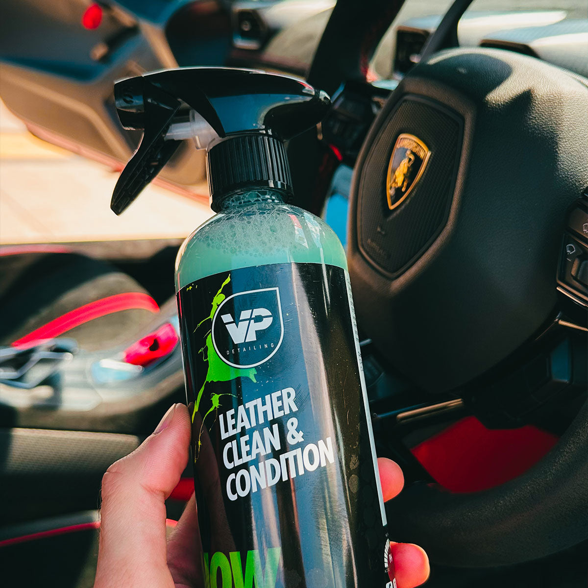 in hand shot of vp detailing leather clean & condition within Lamborghini STO interior 
