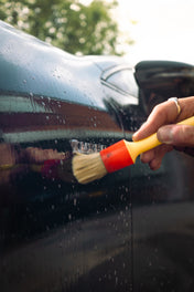 mercedes turbo badge being detailed by a brush