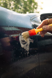 mercedes badge being detailed with a detailing brush