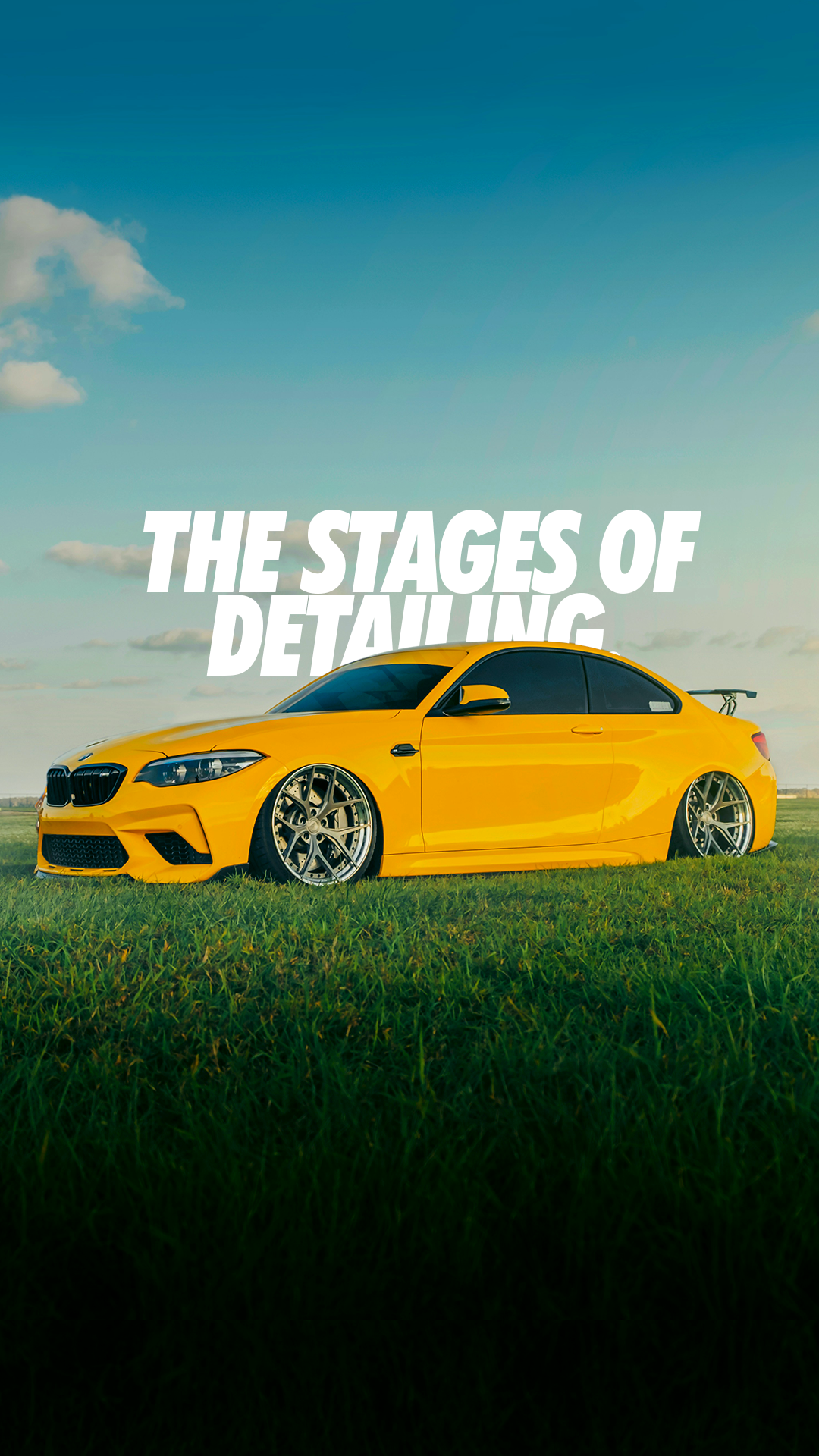 bagged yellow bmw m2 competition with forged wheels in green field stages of detailing 
