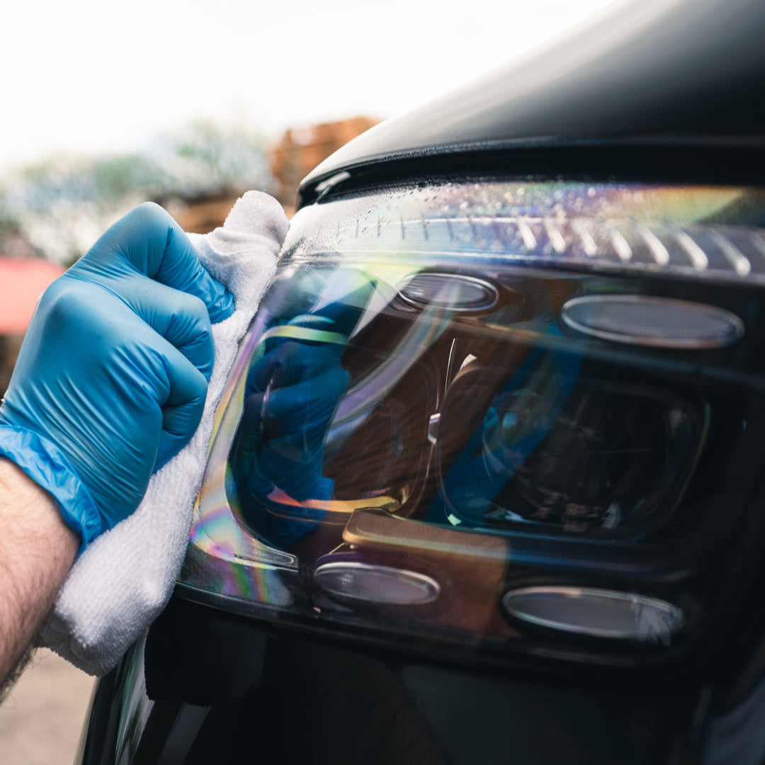 Ceramic glass cleaner being used on automotive headlights