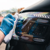 Ceramic glass cleaner being used on automotive headlights