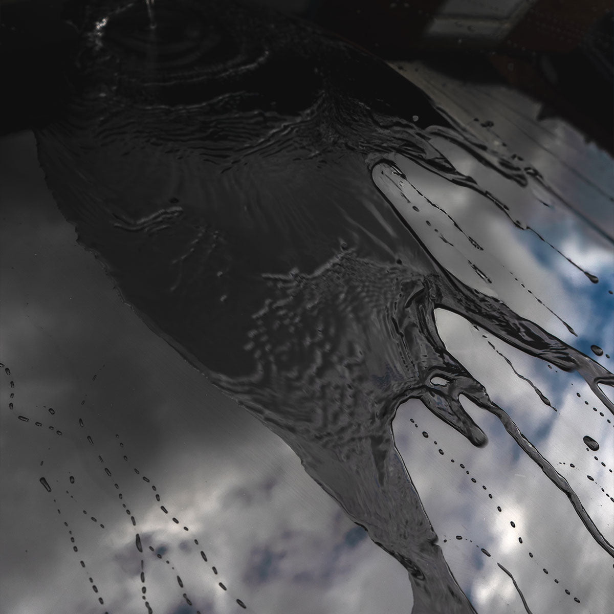 water running off black ceramic coated glossy car