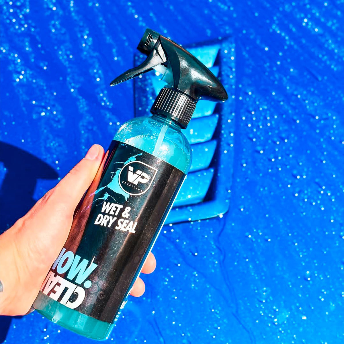 Vp Detailing ceramic drying aid in hand over blue ford with water beading off