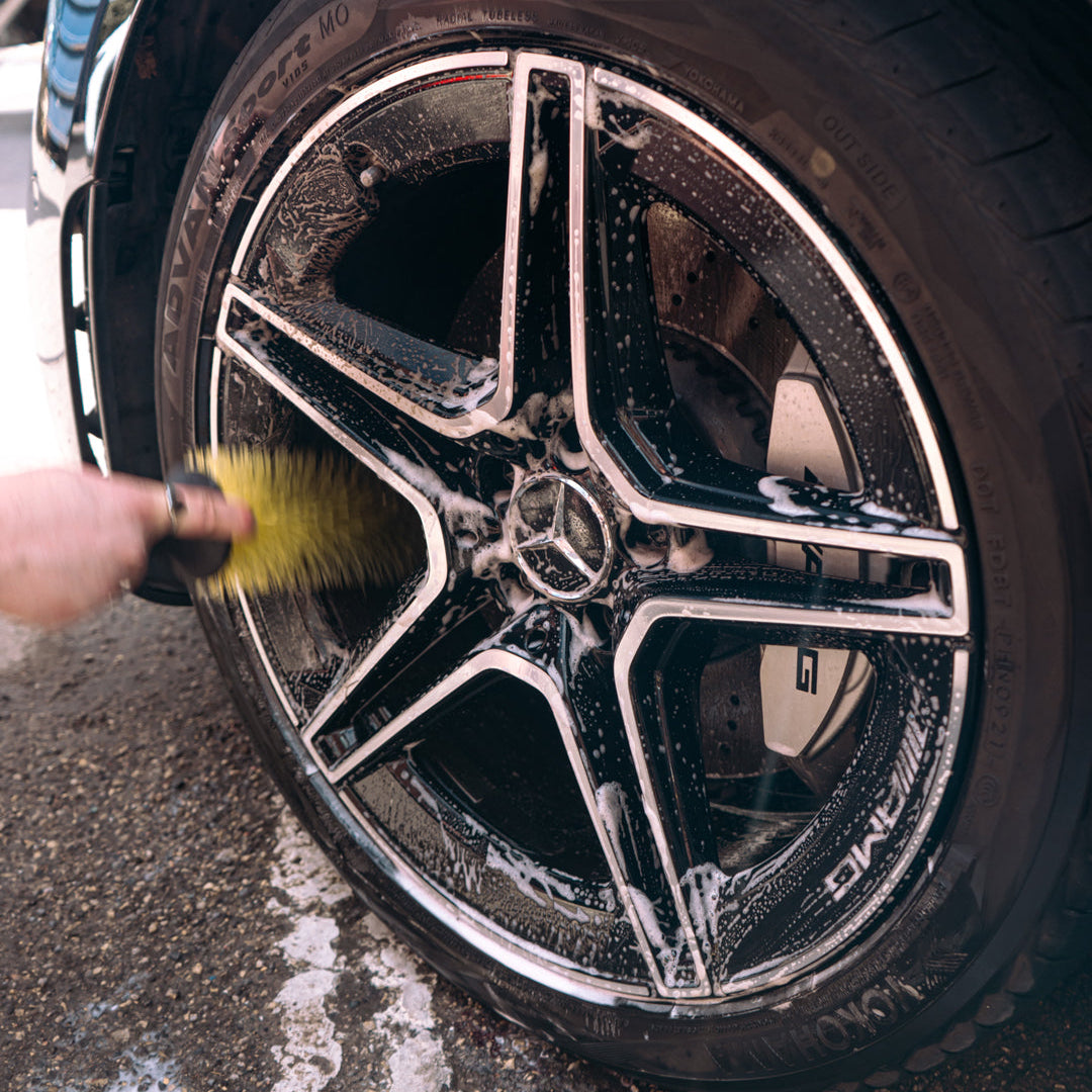 mercedes alloy wheel being detailed and the barrels being brushed with a yellow wheel brush