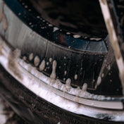 close up of dirt being cleaned away off alloy wheel