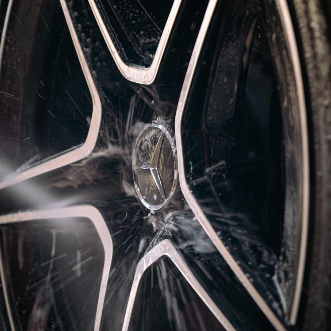 amg wheel being cleaned and rinsed with water