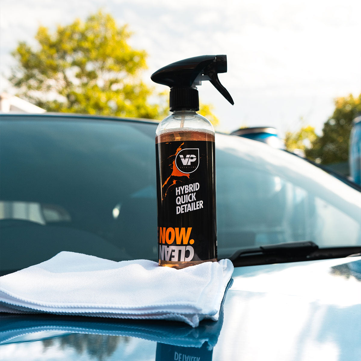 vp detailing hybrid quick detailer sat on top of a white microfibre positioned on hood of shiny car