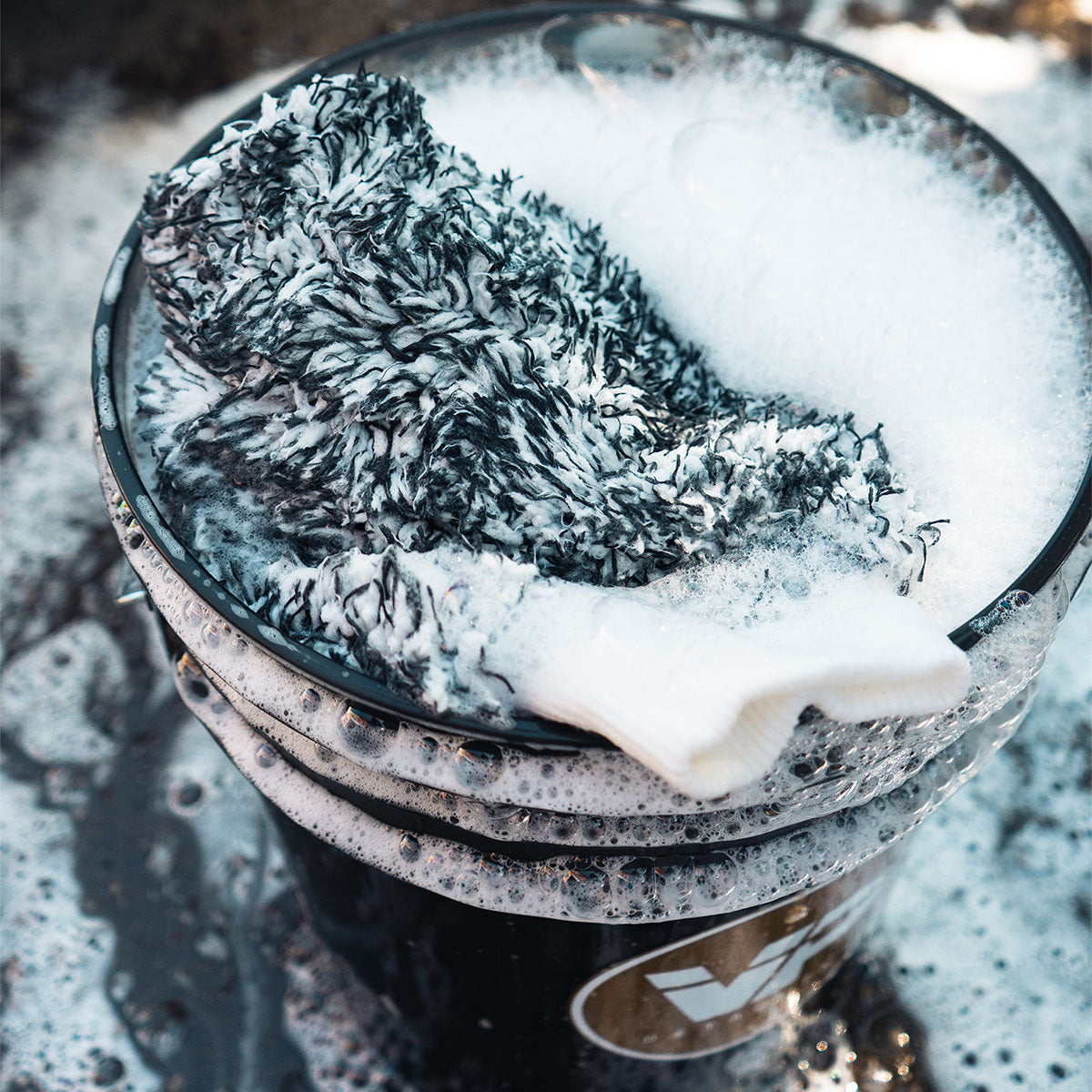 microfibre wash mitt in soapy bucket