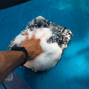 soapy microfibre wash mitt in hand washing car
