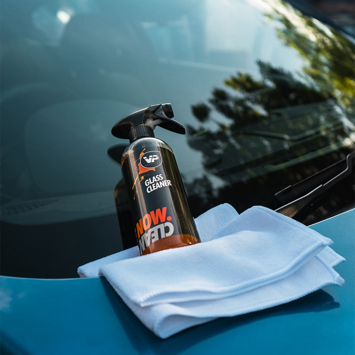 vp detailing glass cleaner product shot lent on car windscreen with white microfibre cloth