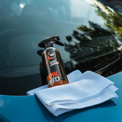 vp detailing glass cleaner product shot lent on car windscreen with white microfibre cloth