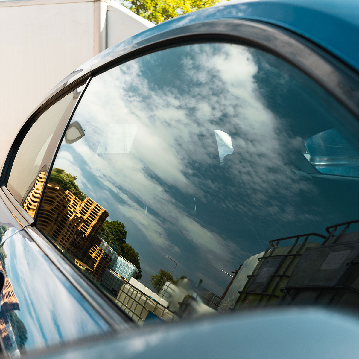 clean window on blue car showing high reflections