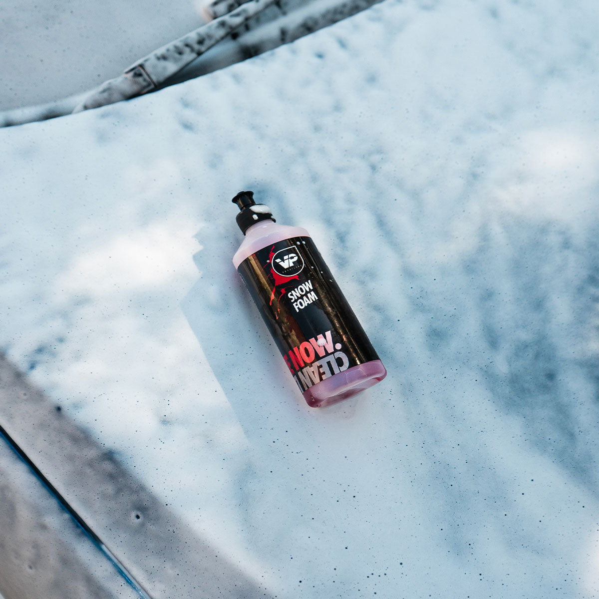 vp detailing snow foam 500ml bottle laid on top of soapy snow foamed car bonnet