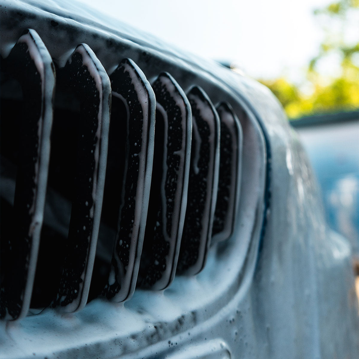 snow foam covering front grille of bmw 