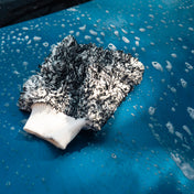 product shot of microfibre wash mitt with suds covering blue car being cleaned